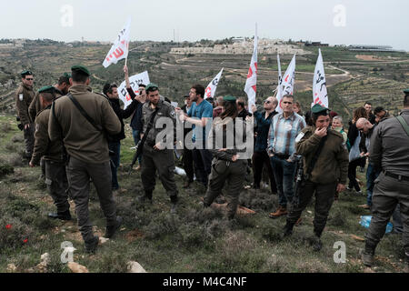 Nativ Ha'avot, Israel. 15th Feb, 2018. Members of the left-wing Peace Now movement taking part in a protest next to the illegal outpost of Nativ Ha'avot on following Israeli government attempts to postpone the removal of some of the houses in the outpost despite the Supreme Court ruling after accepting the petition of a group of Palestinians who argued the homes had been partially built illegally on their land. Credit: Eddie Gerald/Alamy Live News