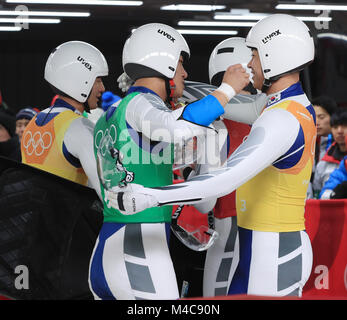 15th Feb, 2018. S. Korean men's luge team Members of South Korea's men's luge team encourage one another after completing the relay race at Olympic Sliding Centre in Pyeongchang, 180 kilometers east of Seoul, on Feb. 15, 2018. South Korea took ninth place. Credit: Yonhap/Newcom/Alamy Live News