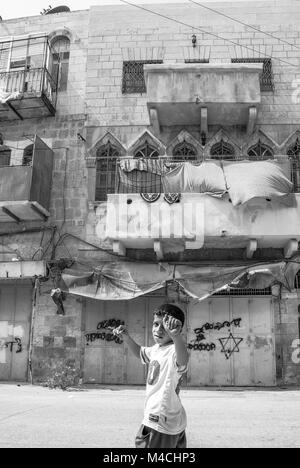 HEBRON, ISRAEL - AUGUST 04, 2010: Vertical picture of muslim palestinian boy at the streets of Hebron, Israel. Stock Photo