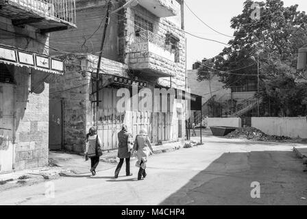 HEBRON, ISRAEL - AUGUST 04, 2010: Black and white picture of muslim women at the streets of Hebron, Israel. Stock Photo