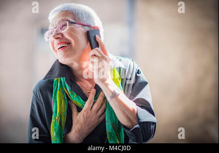 Senior woman having a lovely phone talk Stock Photo