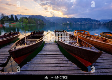 Traditional wooden boats Pletna on the backgorund of Church on the Island on Lake Bled, Slovenia.  Europe. Stock Photo