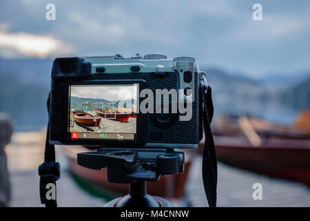 Modern MILC camera on a tripod shooting outdoors photograpy Stock Photo