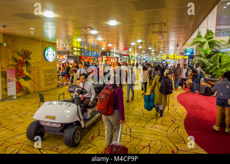 SINGAPORE, SINGAPORE - JANUARY 30, 2018: Indoor view of people walking in a small garden with plants inside of Singapore Changi Airport. Singapore Changi Airport is the primary civilian airport for Singapore Stock Photo