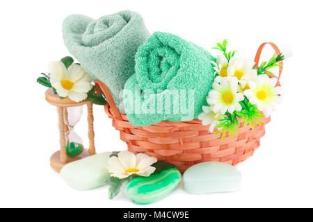 Spa set with towels, soaps, sandglass  and flowers isolated on white background. Stock Photo