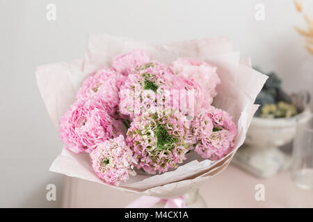 Persian buttercup. lace with many petals. Bunch pale pink ranunculus flowers light background. Wallpaper