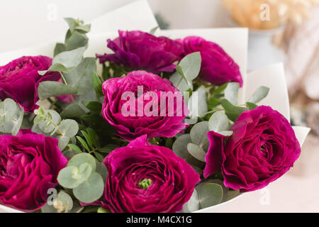 Persian buttercup. lace with many petals. Bunch violet ranunculus flowers light background. Wallpaper