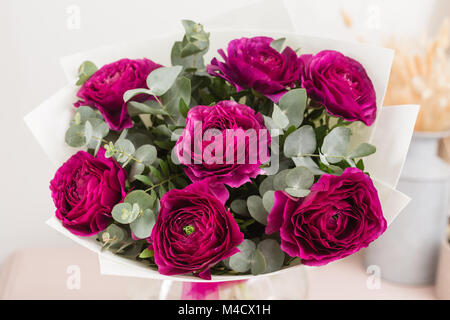 Persian buttercup. lace with many petals. Bunch violet ranunculus flowers light background. Wallpaper