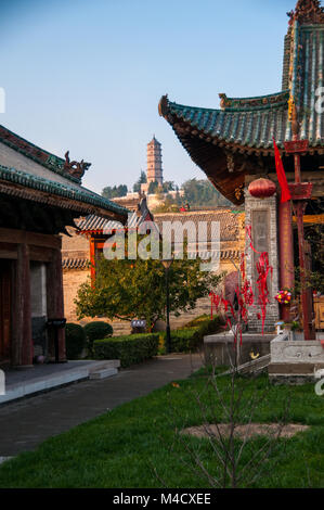 Yuanjue Pagoda framed by buildings of the City God’s Temple (chenghuang) in Hancheng’s old town around dusk. Shaanxi Province, China. Stock Photo
