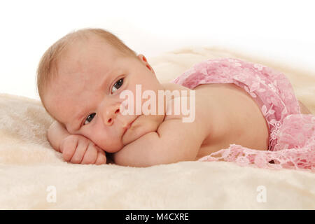 Newborn baby girl relaxing in nursery, beautiful new baby relaxed and happy Stock Photo