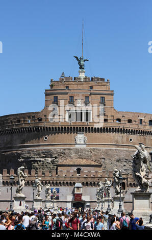 Front view of Castel Sant'Angelo-Castle of the Holy Angel (AKA The Mausoleum of Hadrian) with tourists on the Ponte Sant'Angelo, Rome, Italy. Stock Photo