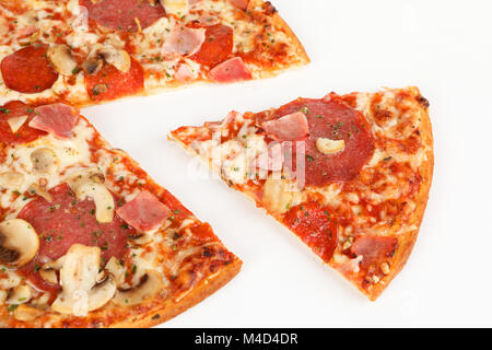 Pizza with salami, ham and mushrooms Stock Photo