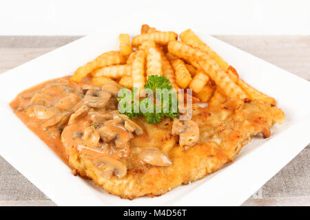 escalope with mushrooms and fries Stock Photo