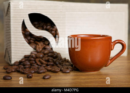 coffee beans spill out of the box on the table Stock Photo