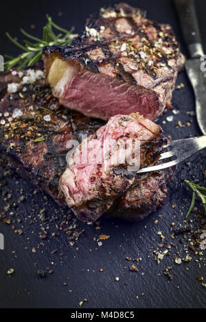 Barbecue Rib Eye Steak on Slate Slab Stock Photo