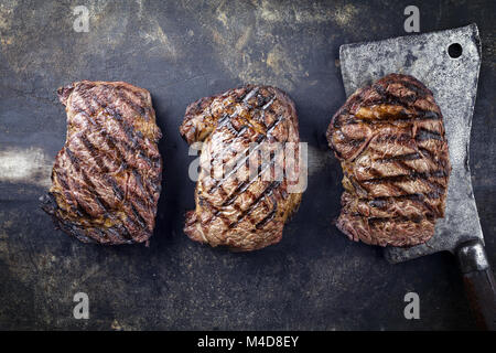 Barbecue Rib-Eye Steaks on old Metall Sheet Stock Photo