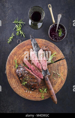 Barbecue Venison Steak on old Cutting Board Stock Photo