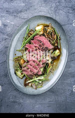 Sliced Point Steak with Thai Vegetable on Plate Stock Photo