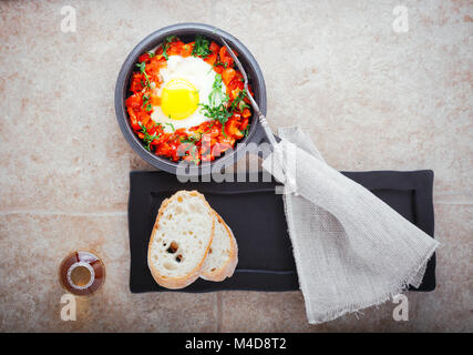 Traditional middle eastern dish of shakshuka in a pan . Stock Photo