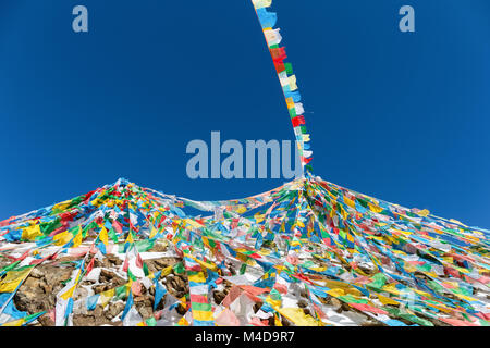 the wind-horse flags against a blue sky in tibet Stock Photo