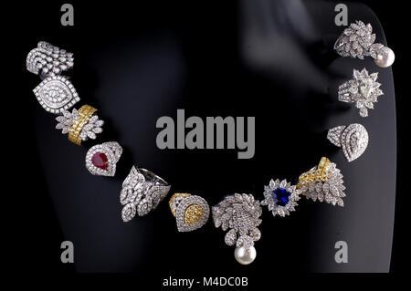 Composition of 12 exclusive precious stones and pearls pieces of jewelry - rings and earrings. Stock Photo
