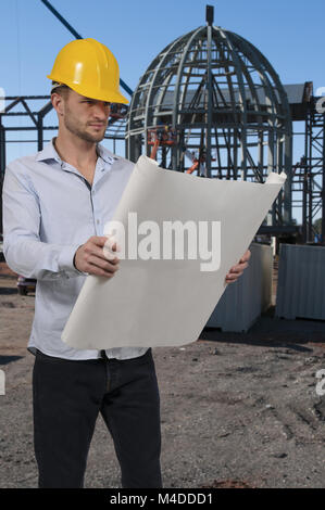 Construction Worker with Blueprints Stock Photo
