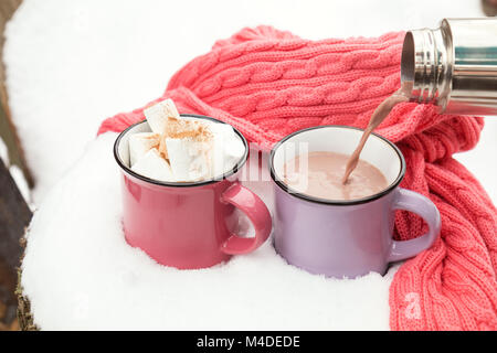 Pouring hot chocolate in the cup Stock Photo