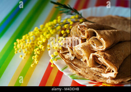Traditional Ukrainian or Russian pancakes with apples on napkins. Traditional dishes on the holiday Carnival Maslenitsa Shrovetide. Stock Photo