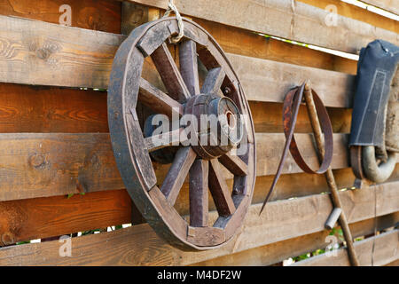wooden wagon wheel on the fence Stock Photo