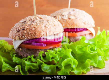 Cheeseburger with salad, onion, tomato and fresh bread Stock Photo