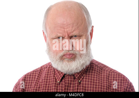 Senior man shows resentful facial expression, isolated on white Stock Photo