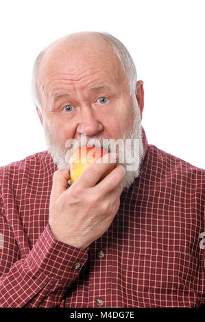 Cheerfull senior man eating the apple, isolated on white Stock Photo