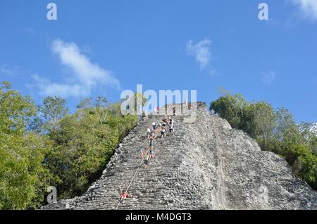 Tourists climbing  stone Temple at Coba Yucatan Mexico Stock Photo