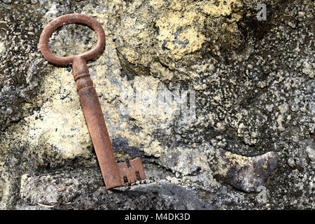 very old door key in rusty iron Stock Photo
