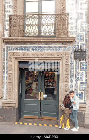 A couple stands outside the Casa de Los Azulejos (House of Blue Tiles) in Mexico City, Mexico. Stock Photo