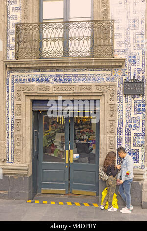 A couple stands outside the Casa de Los Azulejos (House of Blue Tiles) in Mexico City, Mexico. Stock Photo