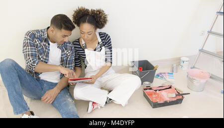 After long day of painting young couple sit Stock Photo
