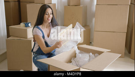 Smiling happy woman packing up her home Stock Photo