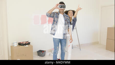 Man using virtual reality glasses gets help Stock Photo