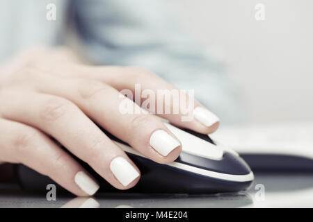 Female hand using computer mouse Stock Photo