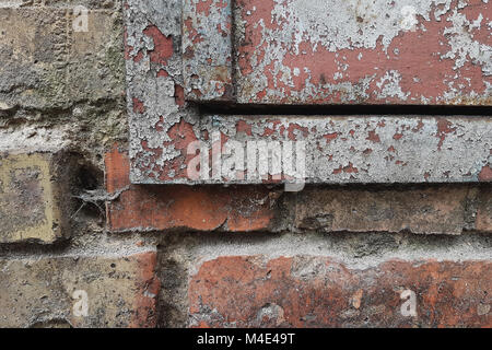 Abstract grunge texture fragments rusty metal surface and ruined bricks old wall, in the cracks of the gray cobweb. Stock Photo