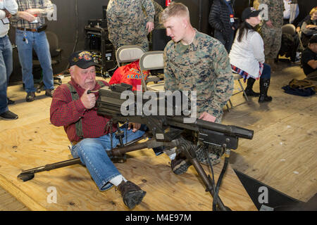 A member of the Second Marine Division Association (SMDA) sights in using a MK-19 on a simulated target inside of the Division Combat Skills Center on Camp Lejeune, N.C., Feb. 8, 2018. The SMDA is aboard Camp Lejeune to celebrate the 2nd Marine Division’s 77th anniversary. (U.S. Marine Corps Stock Photo