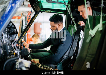 Ryan Coogler, “Black Panther” director, sits in the cockpit of a UH-1N Iroquois during a tour at the 1st Helicopter Squadron at Joint Base Andrews, Md., Feb. 11, 2018. Coogler took the opportunity to learn more about JBA Airmen and the mission they do each day before arriving at the free military appreciation showing of their film. (U.S. Air Force Stock Photo