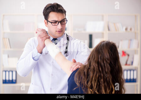 Traumatologist is taking care of the patient Stock Photo