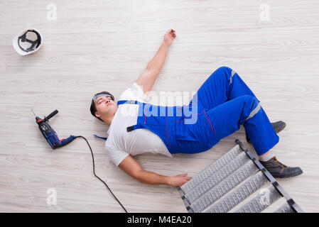 Worker after falling from height - unsafe behavior Stock Photo