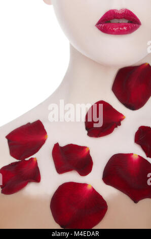 white woman with red lips and rose petals Stock Photo