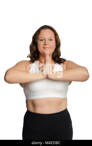 Fat woman is engaged in pilates in a fitness gym. A girl with a lot of  overweight trying to lose weight with the help of yoga, does exercises for  side Stock Photo 