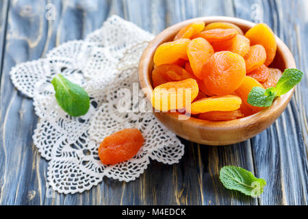 Dried apricots in wooden bowl. Stock Photo