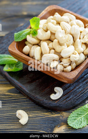 Cashew nuts in a wooden bowl. Stock Photo