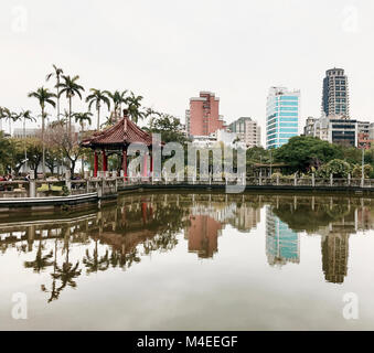 Skyscrapers reflected in a lake, Peace Park, Taipei, Taiwan Stock Photo